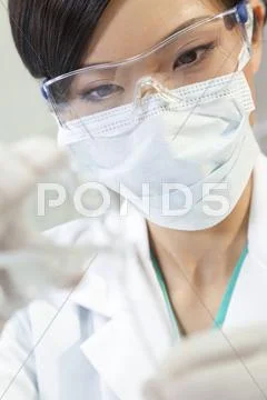 Chinese female woman scientist with test tube in laboratory Stock Photos