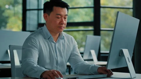 Chinese focused man professional worker asian successful 40s businessman sit at Stock Footage 219889348