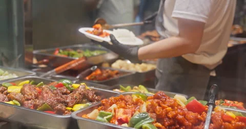 Chinese food buffet worker serving rice and stir-fry dishes Stock Footage 344475218