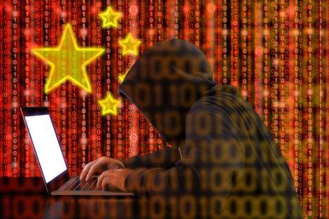 Chinese hacker at work in front of red flag 写真素材