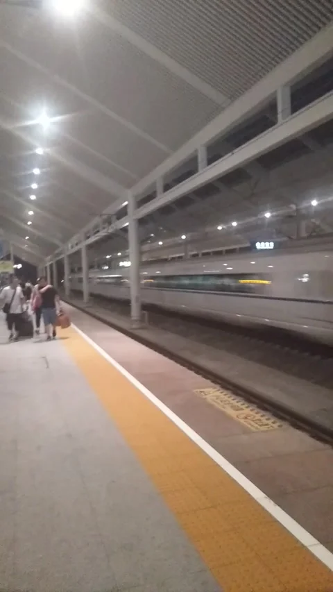 Chinese High speed rail passing train station at 300km/h Stock Footage 201027024