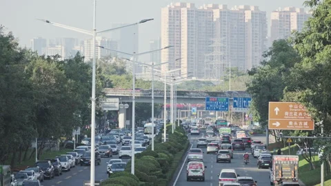 Chinese Highway Flow: Non-Stop Traffic with Distant City Skyline and High-Rises Stock Footage 322019326