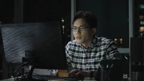 Chinese IT worker working in office at night,4K Stock Footage 243449219