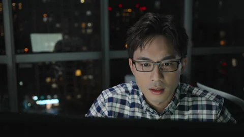 Chinese IT worker working in office at night,4K Stock Footage 243451013