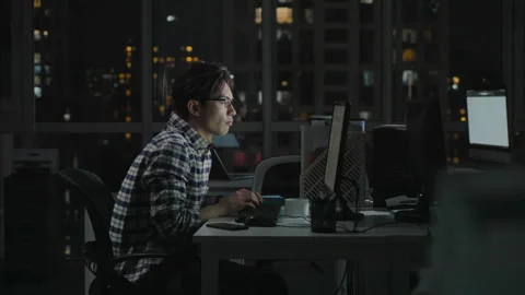 Chinese IT worker working in office at night,4K Stock Footage 243458980