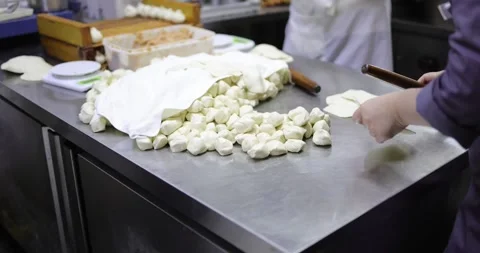 Chinese Kitchen Workers Making Dumplings ROlling Dough Slow Motion 4K Stock Footage 263036879