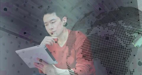 Chinese man analyzing tablet data and resting chin in modern office, with global Stock Photos