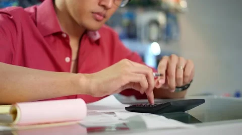 Chinese Man With Calculator Checking Bills In Computer Shop Stock Footage 48784496