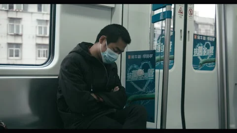 Chinese man on commuter train, post-lockdown Wuhan, China Stock Footage 132584784