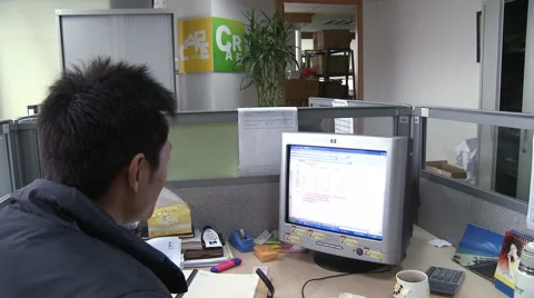 Chinese man at computer in modern office Stock Footage 54247045