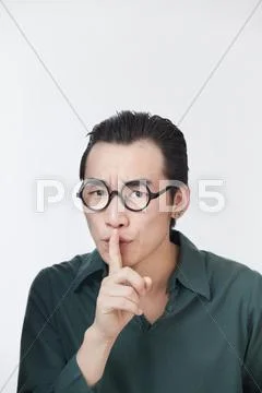 Chinese man making shhh gesture Stock Photos