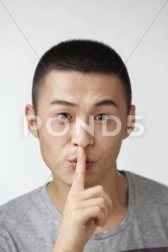Chinese man making shhh gesture Stock Photos