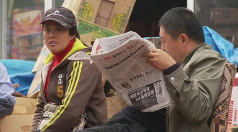 Chinese man reading newspaper Stock Footage 54437513