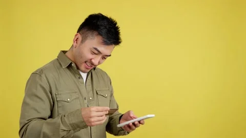 Chinese man using the mobile and card to shopping online Stock Footage 233523588