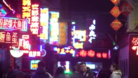 Chinese markets, crowd of people under neon lights, Shenyang, China Stock Footage