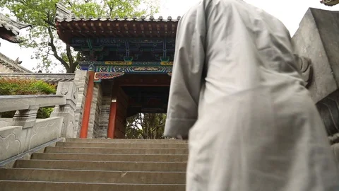 Chinese monk walking up the staircase Video stock 88828811
