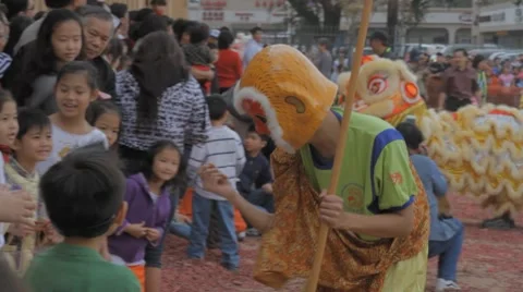Chinese Monkey King Playing with Children During A Chinese New Year Festival Stock Footage 8691217