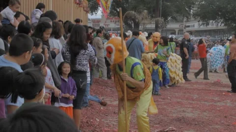 Chinese Monkey King Playing With a Crowd During A Chinese New Year Festival Stock Footage 8691242