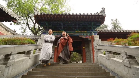 Chinese monks walking down the staircase Stock Footage 88728355