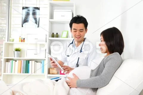 Chinese mother pregnant medical checkup with doctor Stock Photos