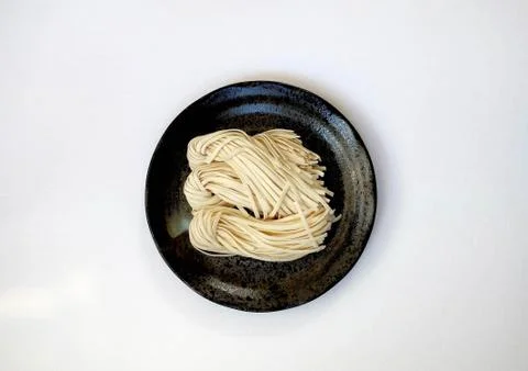 Chinese Noodles on Black Plate Stock Photos
