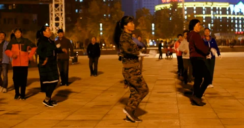 Chinese old people synchronized dancing at night outdoors for chinese new year Stock Footage 103312947
