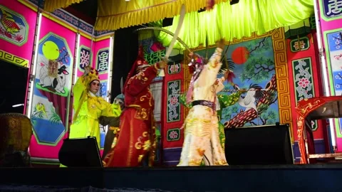 Chinese opera actors performing on roadside stage during religious celebrations Video stock 317923531