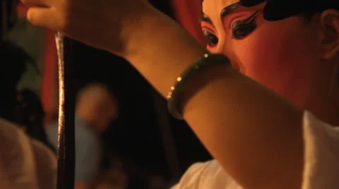 A Chinese opera performer applies make-up before performing Video stock 60756925
