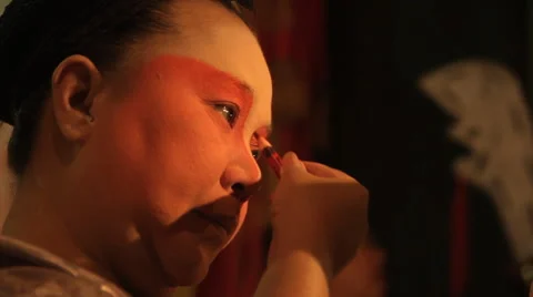 Chinese opera performer applies make-up before performing Stock Footage 60760476