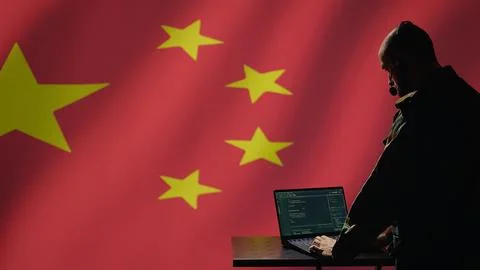 Chinese operative coding on laptop, developing program able to deploy bots Stock Photos
