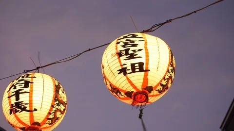 Chinese Orange Paper Lanterns Dangling in Wind During Evening Stock Footage 107345994