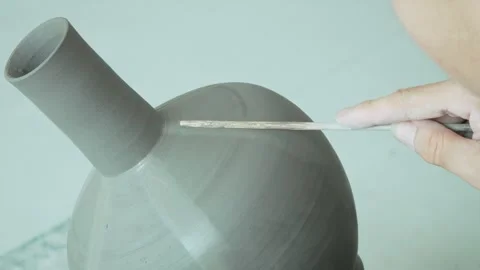 Chinese Potter Creating Raised Linear Ridges on Spinning Clay Vase Stock Footage 338185156