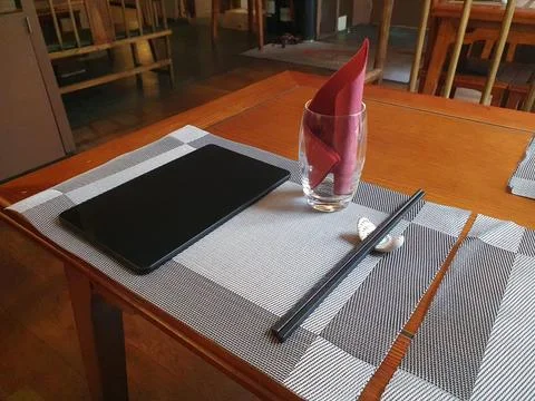 Chinese restaurant empty dinner placement with napkins and chopsticks and t.. Stock Photos