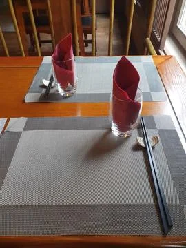 Chinese restaurant empty dinner placement with napkins and chopsticks Stock Photos