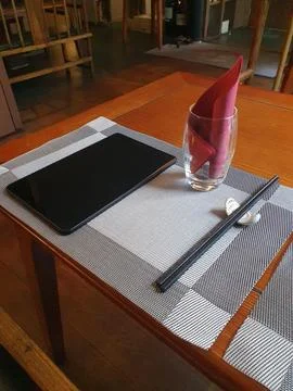 Chinese restaurant empty dinner placement with napkins and chopsticks and t.. Stock Photos