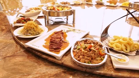 Chinese restaurant in the hotel. Round table with twisting dishes of Chinese cui Stock Footage 81079657