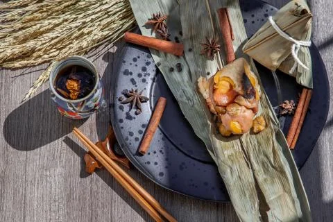 Chinese rice dumpling shaped pyramidal wrapped by leaves ingredients. Stock Photos