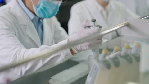Chinese scientist pipetting samples in laboratory,4K Stock Footage 238586348