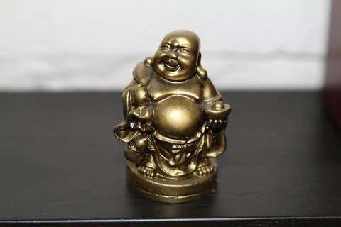 Chinese statuette, fat man with money. Stock Photos