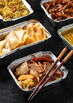 Chinese takeaway food. Kung Po king prawns, crispy won ton, roast pork char siu Stock Photos
