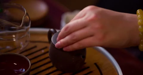 Chinese tea ceremony. The tea master pours the tea into the teapot Stock Footage 101031063