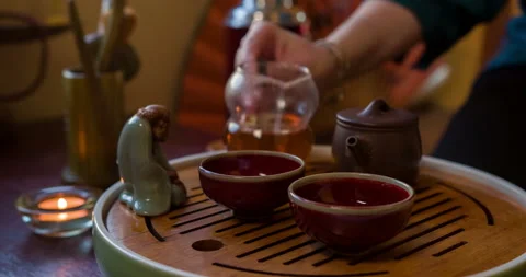 Chinese tea ceremony. A tea master pouring tea into the cups Stock Footage 105187463