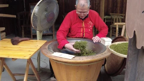 Chinese tea farmer manually frying tea leaves Stock-Footage 337522638