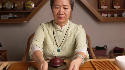 Chinese tea master presenting a cup of tea Stock Footage 217369871