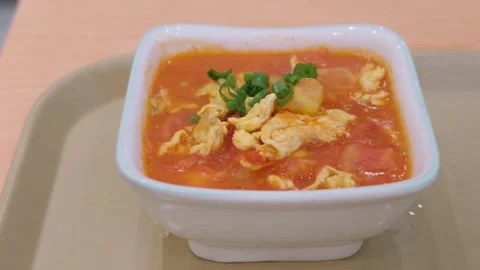 Chinese Tomato and Scrambled Egg Soup with Spring Onion Stock Footage 345967561