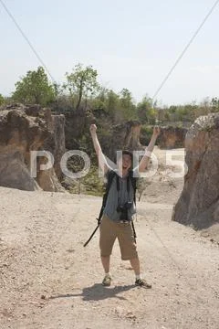 Chinese tourist laughing with arms raised Stock Photos