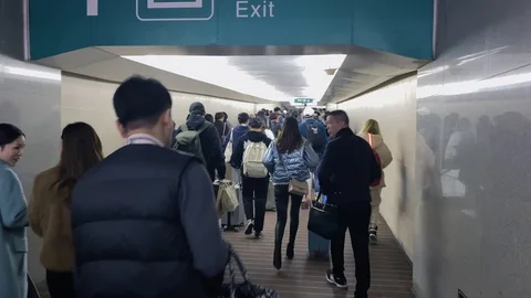 Chinese tourists get off the train and enter the exit channel Vídeos de archivo 123740316