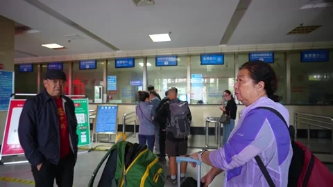 Chinese tourists queuing at bus station ticket counter Stock Footage 335214531