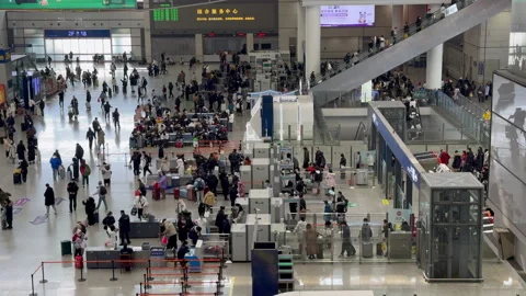 Chinese travellers in queue for security check at Railway Station Stock Footage 264989103