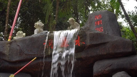 Chinese waterfall with monkey statues at temple Video stock 91123015